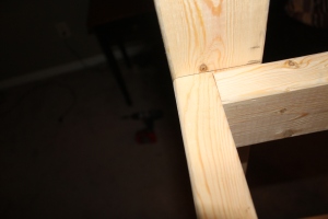 Close up of the rectangle shelf supports attached to the post.  We attach 4 screw on the outside of each shelf  angle support to add extra strength to each 