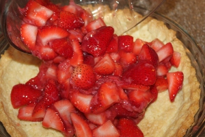 Pour the well coated strawberries into the cooled pie crust